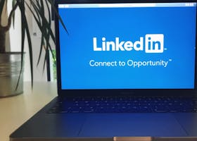 A laptop screen displaying the LinkedIn logo with the text 'Connect to Opportunity'.