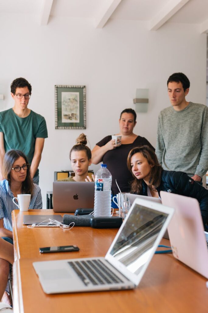 Group of young professionals engaged in a collaborative meeting in a modern office setting.